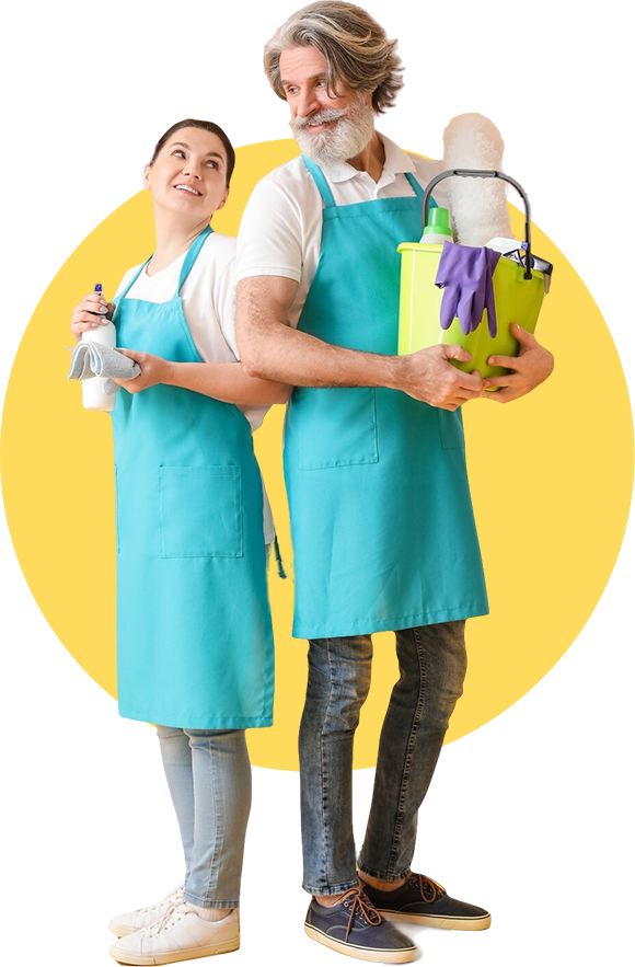 Two people wearing aprons and holding cleaning supplies, ready to clean.