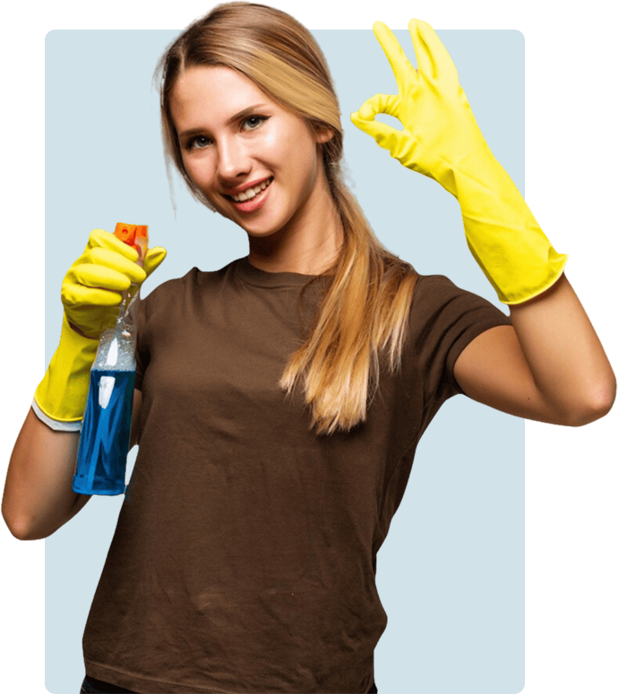 A smiling woman wearing yellow gloves and holding a spray bottle, making an ok sign with her hand.