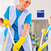Cleaning staff working in a bright room.